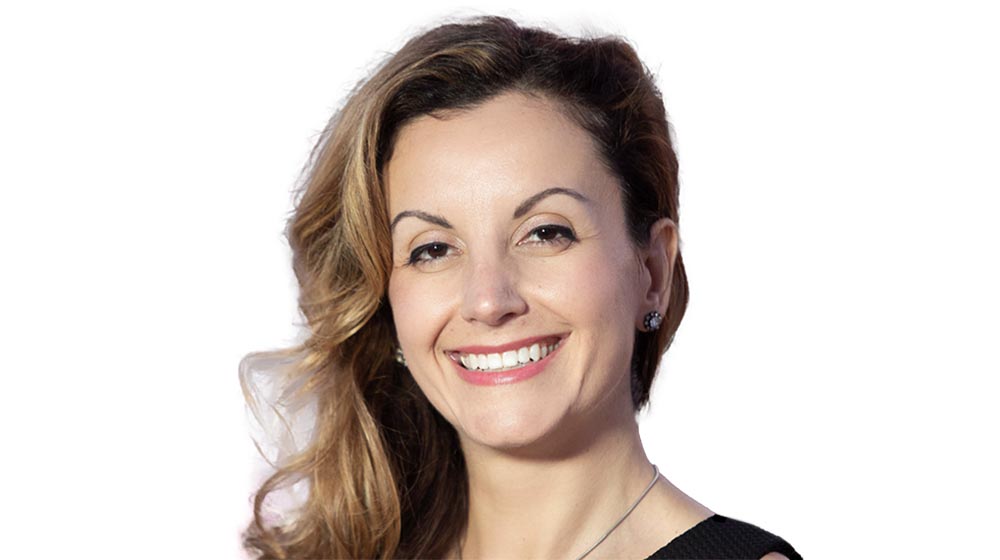 Portrait of a smiling woman against a light background